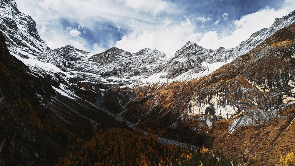 双桥沟四姑娜措高山湖泊中的雪山倒影,蓝天白云映衬碧绿湖水